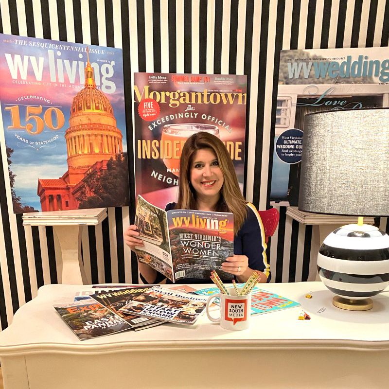 Nikki Bowman holding a WV Living magazine in her office.