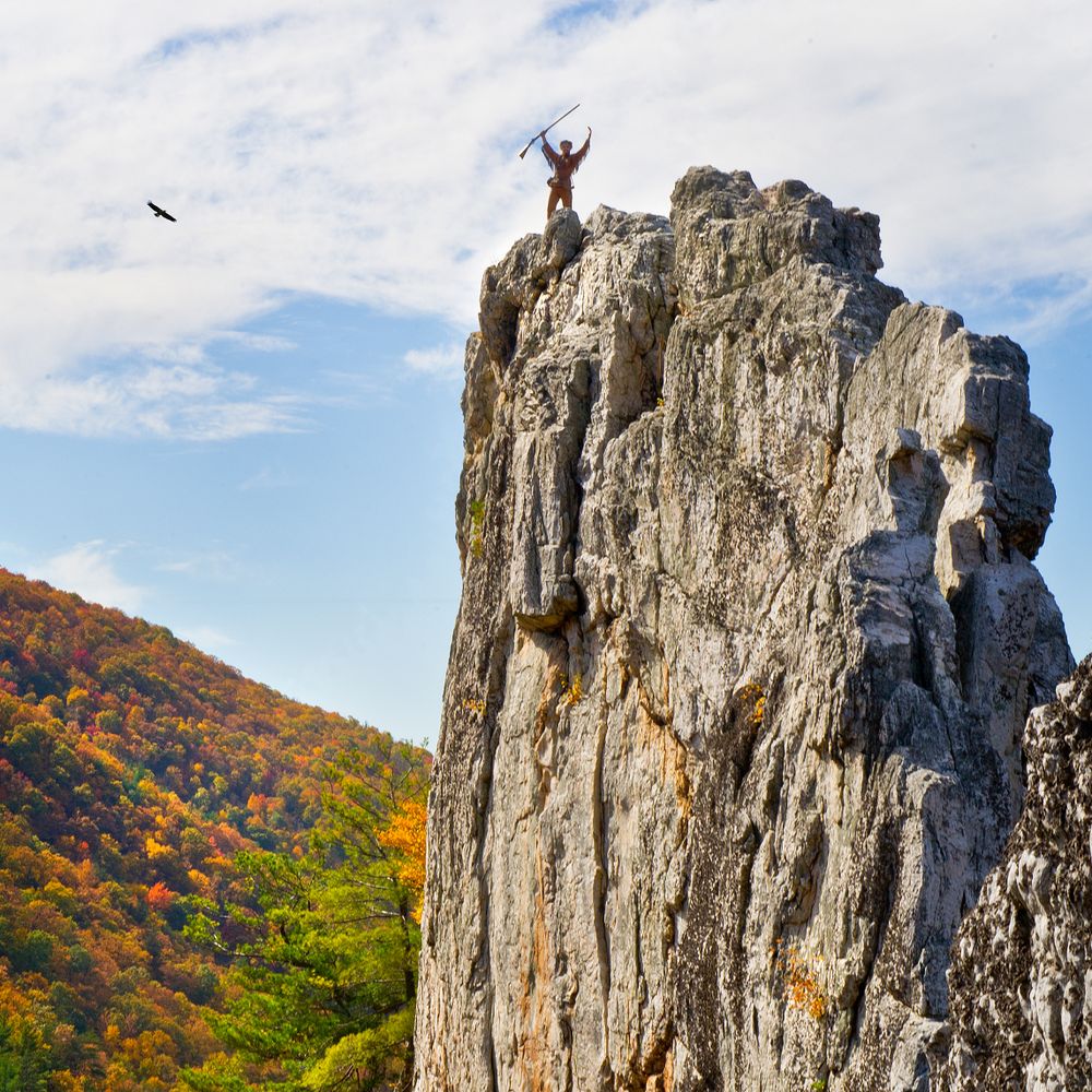 Mountaineer Mascot Jonathan Kimble standing on Seneca Rocks.