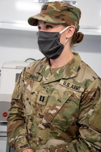 Photo of Samantha Fabian in fatigues and wearing mask.