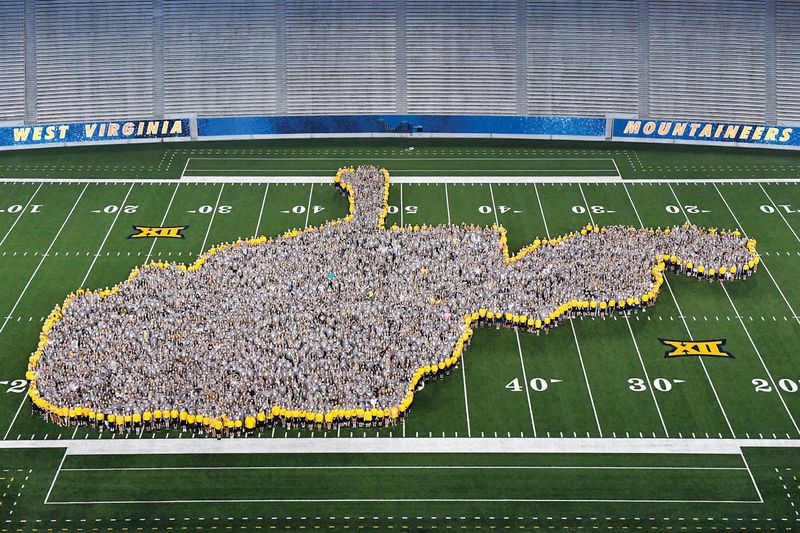 Freshman class stands within the outline of the state of West Virginia.
