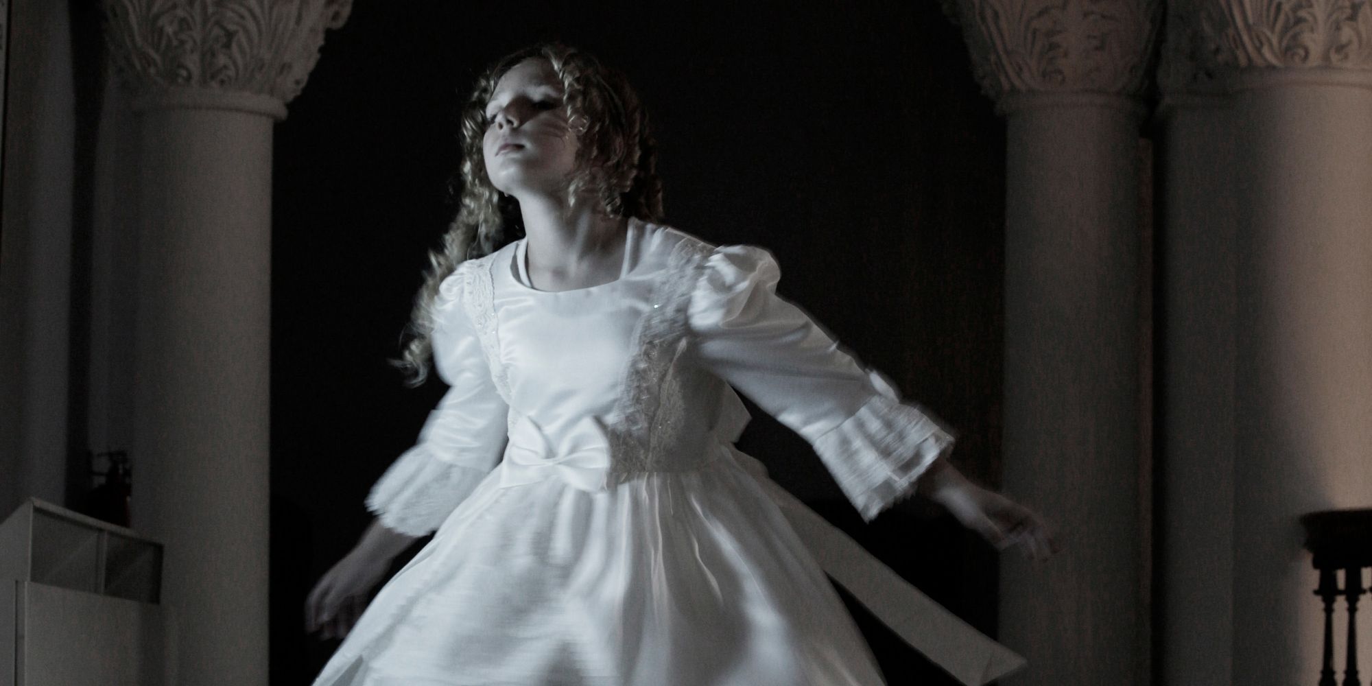 A ghostly girl spins in her party dress.