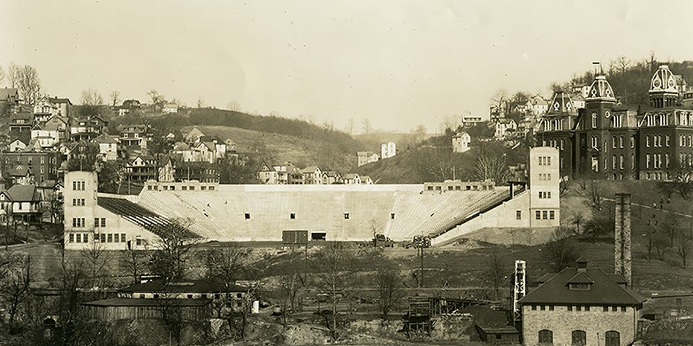A photo of old Mountaineer Field next to Woodburn Hall as seen across the river from Westover.