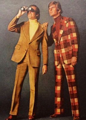 Photo of man wearing plaid suit and other man wearing brown perhaps velvet suit and looking through binoculars. 