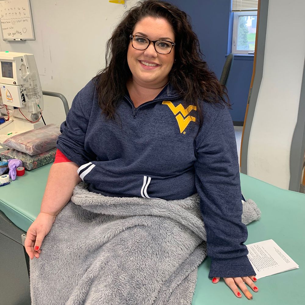 Marisa Leuzzi in a sweatshirt at a hospital having just given blood.