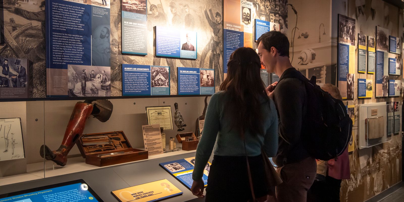 two people look at museum exhibit