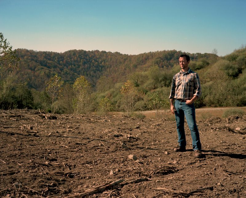 Ben Gilmer stands on land that Refresh Appalachia is reworking for agriculture.