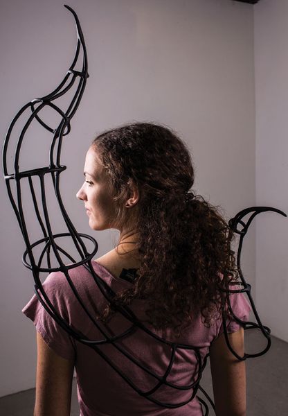Kari Kindelberger wears an iron sculpture.