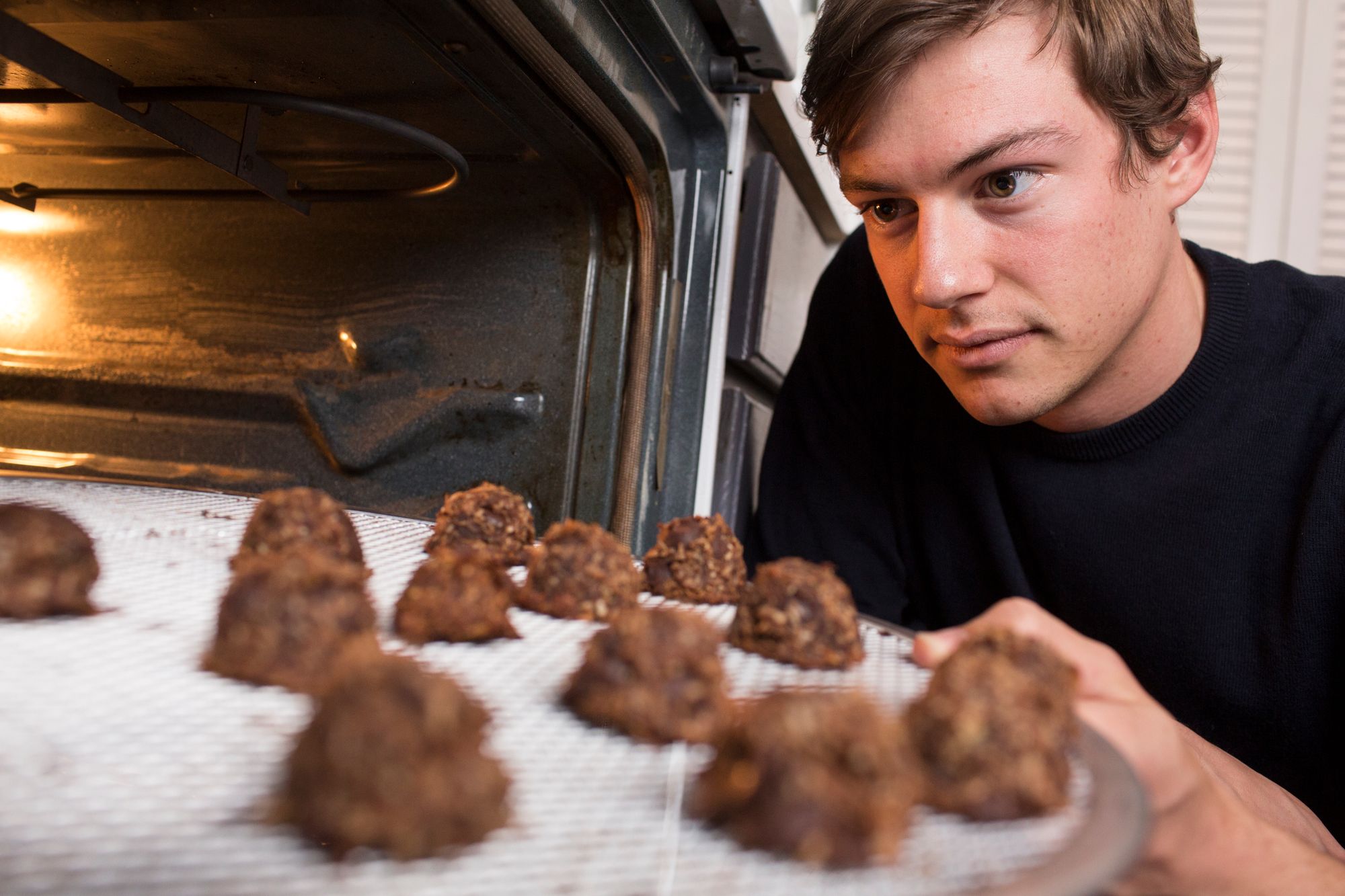 Tommy Brown looks at his energy bars in the oven.