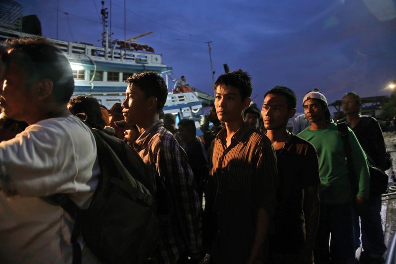 Burmese Fishermen prepare to board a boat during a rescue.