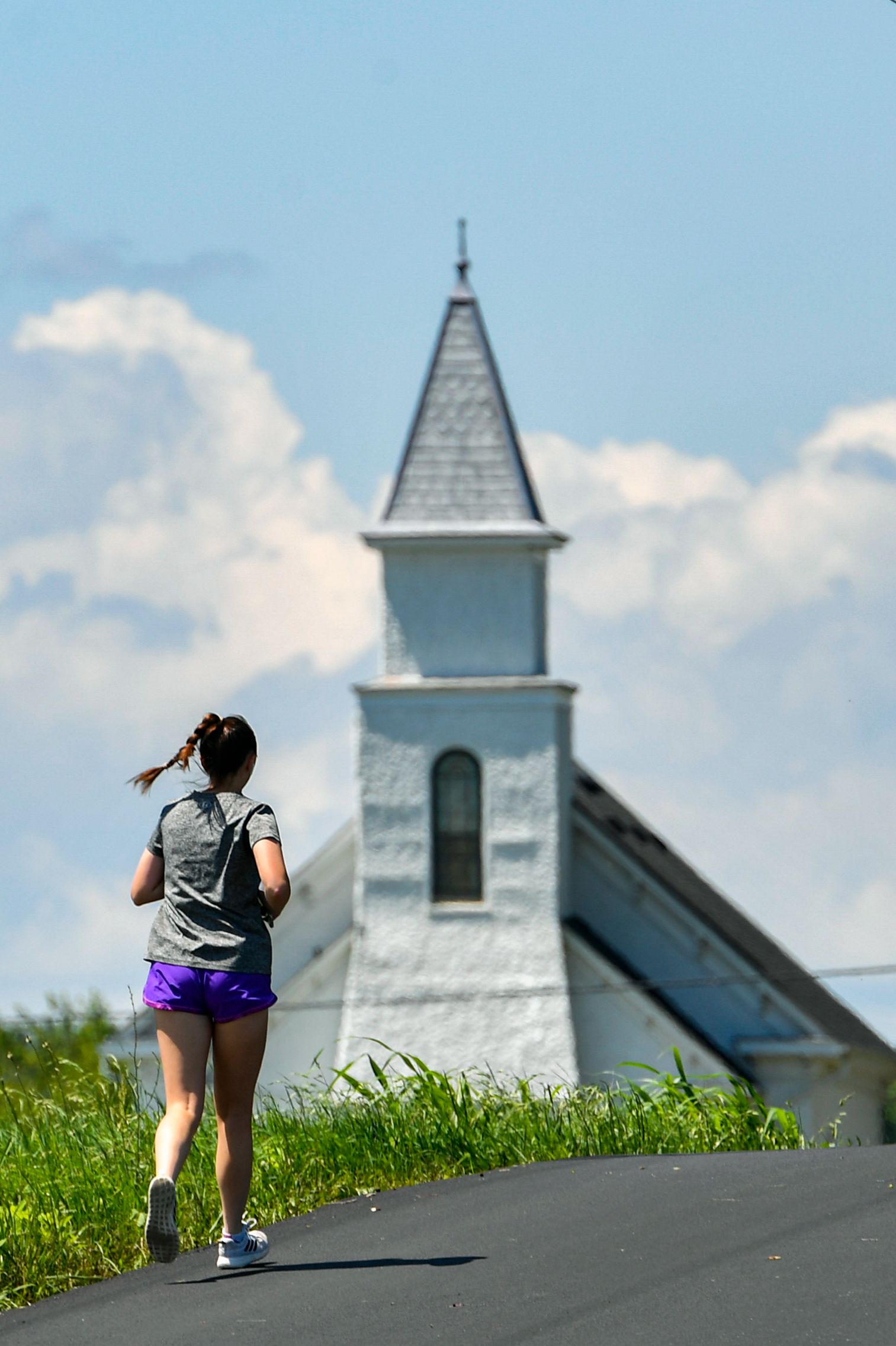 A woman runs past a church near Shepherdstown. 