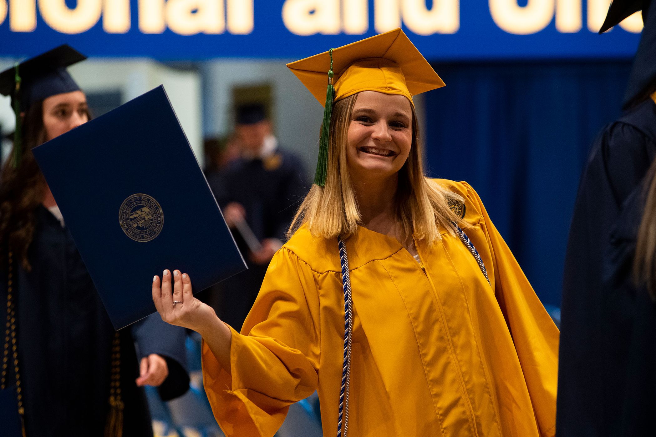 woman shows her diploma