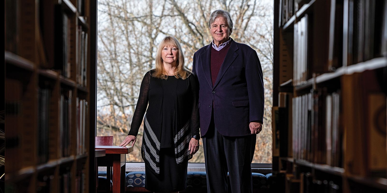 Suzanne Weise and Pat McGinley stand in the law library at WVU.