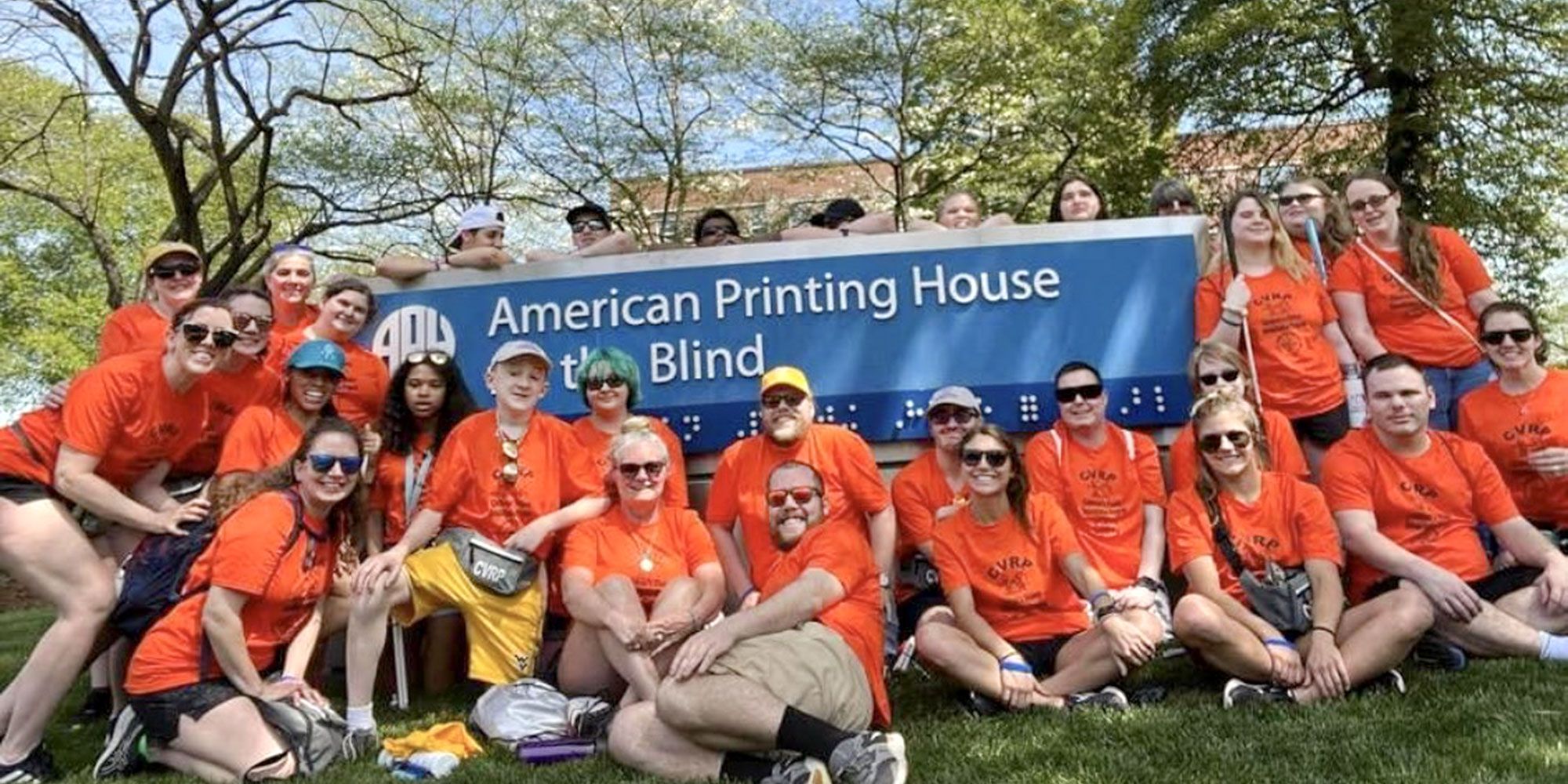 students from CVRP pose in front of publishing house for the blind sign