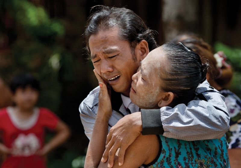 Myint Naing and his mother cry as they are reunited after 22 years. 