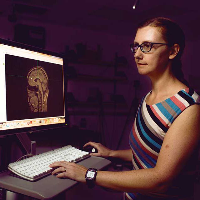 Valeriya Gritsenko looks at the image of a brain on a computer screen.
