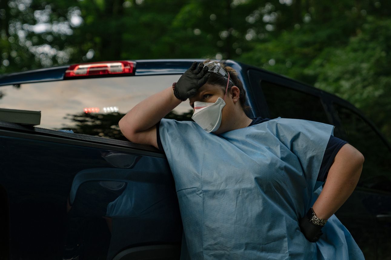 A Marion County EMS medic waits for the county medical examiner to arrive on the scene of a deceased man believed to have been infected with COVID-19 on August 6th, 2020. 