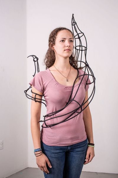 Kari Kindelberger wears an iron sculpture.